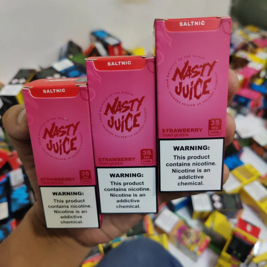 Three boxes of Nasty Juice Strawberry flavor vape juice held in hand