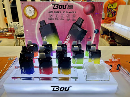 Display of vape devices with 'Bou' branding on a table.