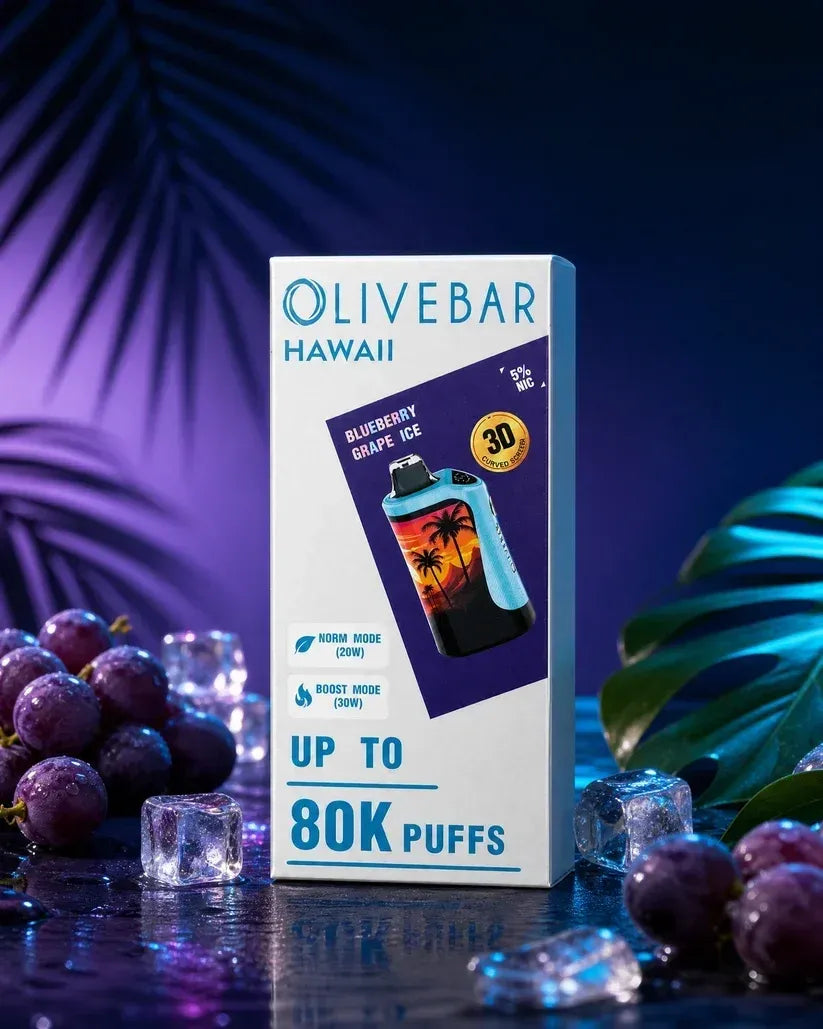 Olivebar Hawaii disposable vape packaging box standing upright on a dark reflective surface, surrounded by purple grapes, ice cubes, and tropical leaves under blue and purple lighting. The box reads 'OLIVEBAR HAWAII', 'BLUEBERRY GRAPE'S ICE', 'UP TO 80K PUFFS', and shows a blue and black vape device with a sunset graphic.