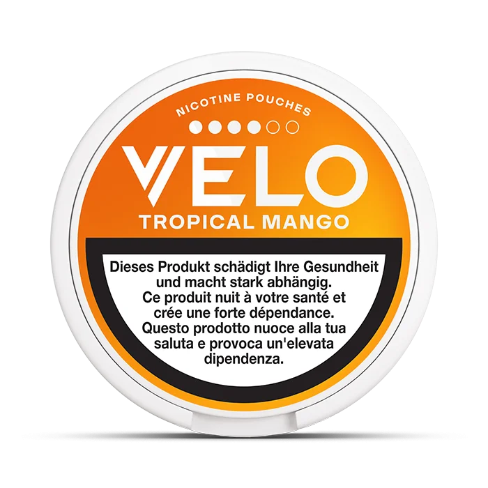 VELO Tropical Mango nicotine pouch container with warning labels on an orange background