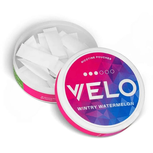 Open container of VELO nicotine pouches with colorful lid displaying 'Wintry Watermelon' flavor.